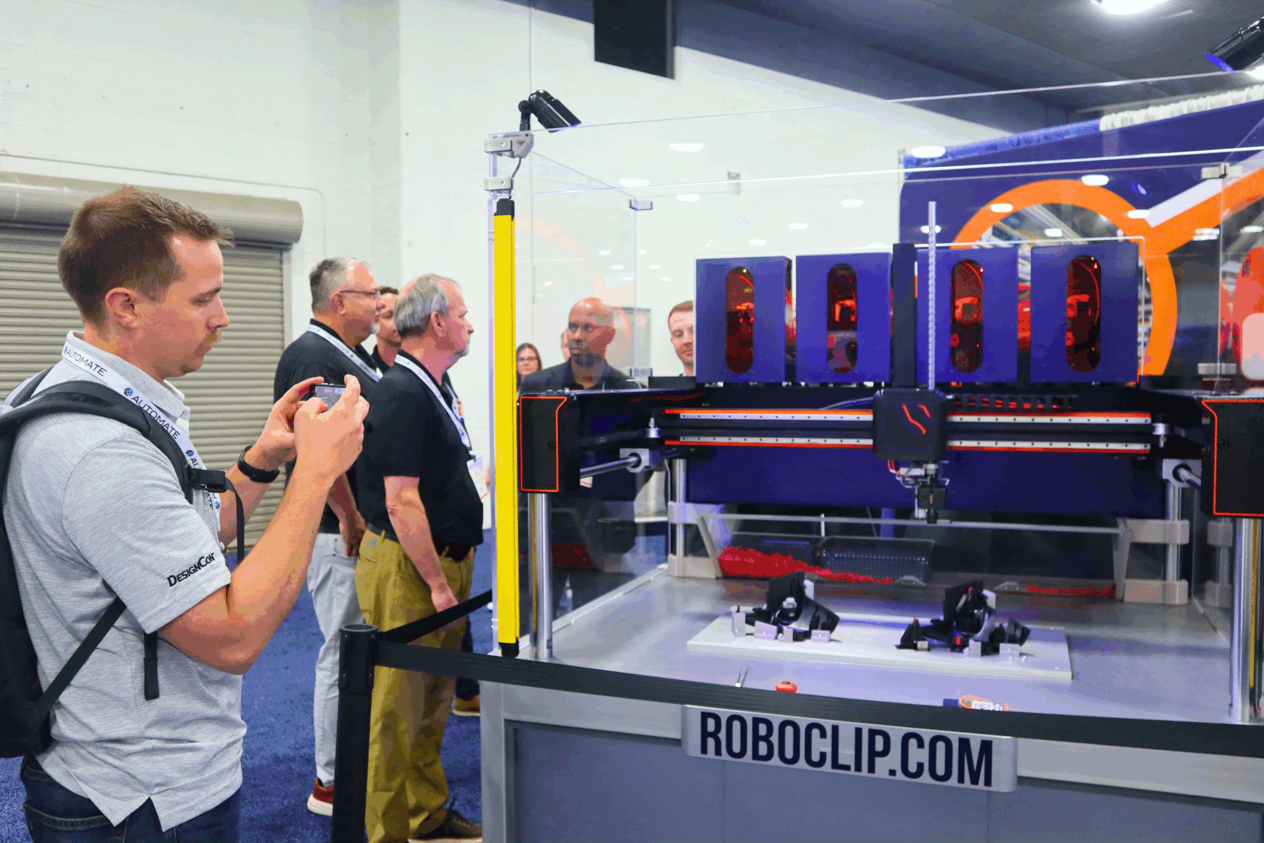 People taking pictures of RoboClip at Automate Show 2025