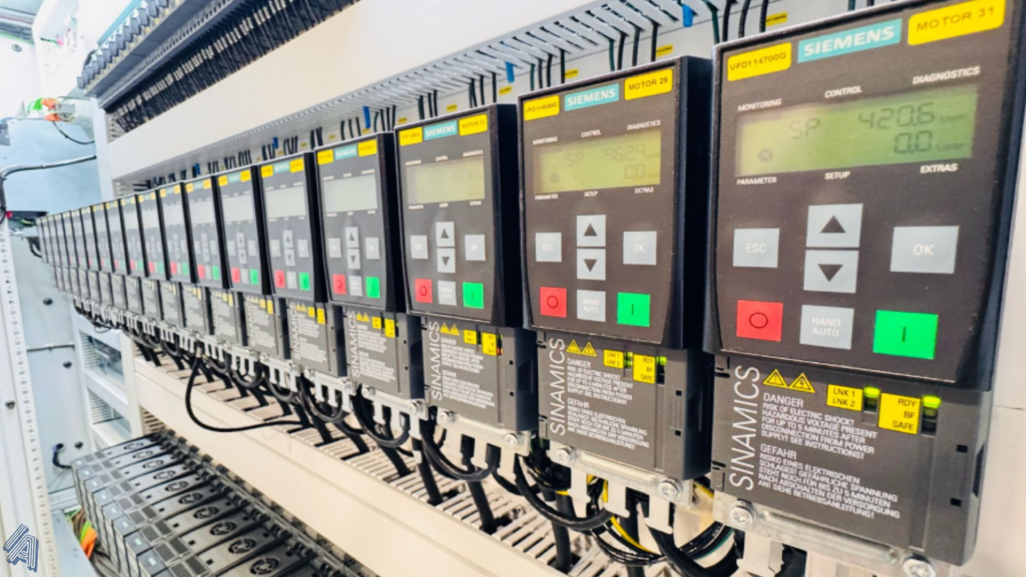 Row of Siemens SINAMICS variable frequency drives installed in an industrial control panel