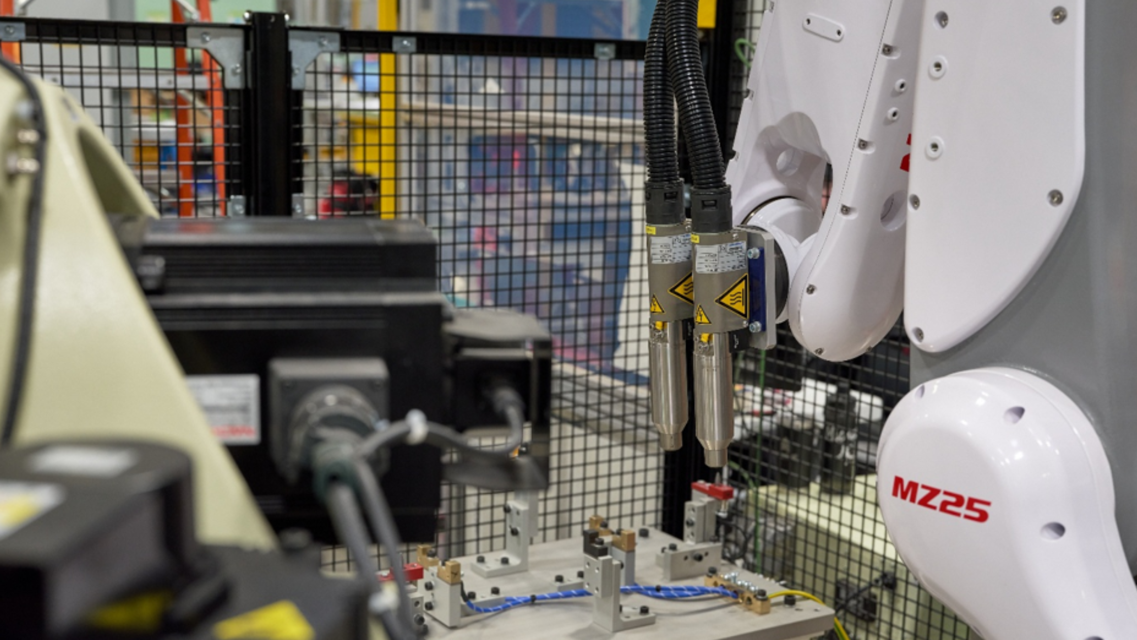 Atmospheric plasma treatment nozzles mounted on an industrial robotic arm for automated surface preparation.